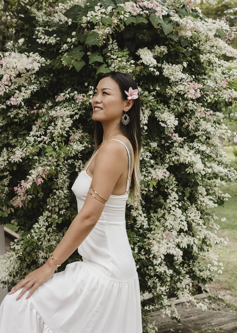 Alice Muse standing among pale flowers