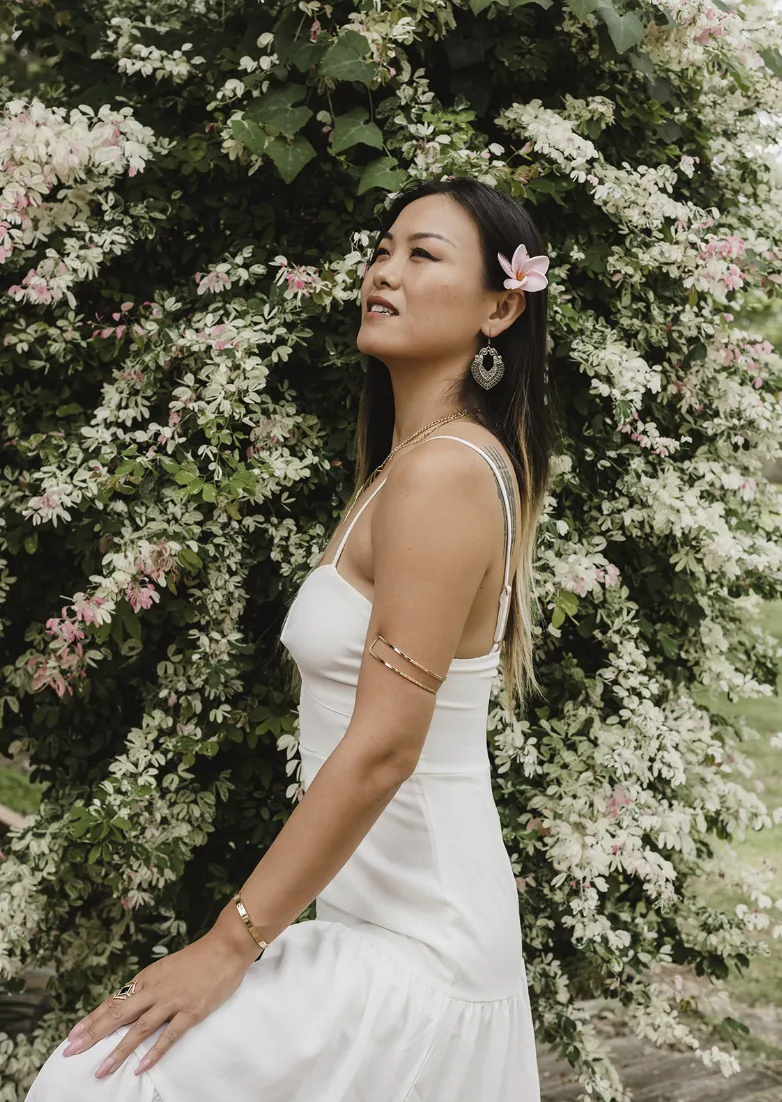 Alice Muse smiling among pale flowering branches
