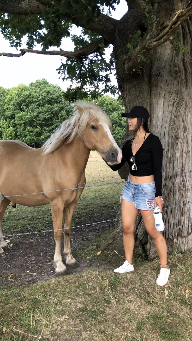 Alice standing beside Prince Charming beneath a large tree