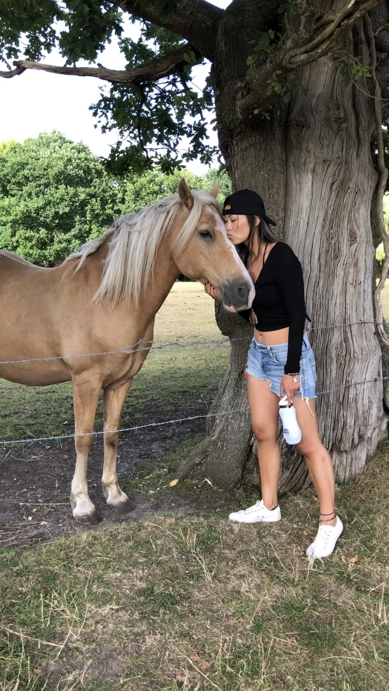 Alice standing close to Prince Charming beneath the tree