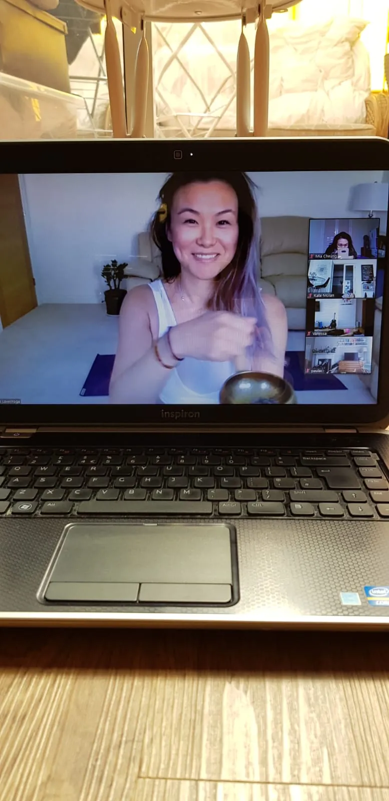 Alice teaching yoga through a laptop screen